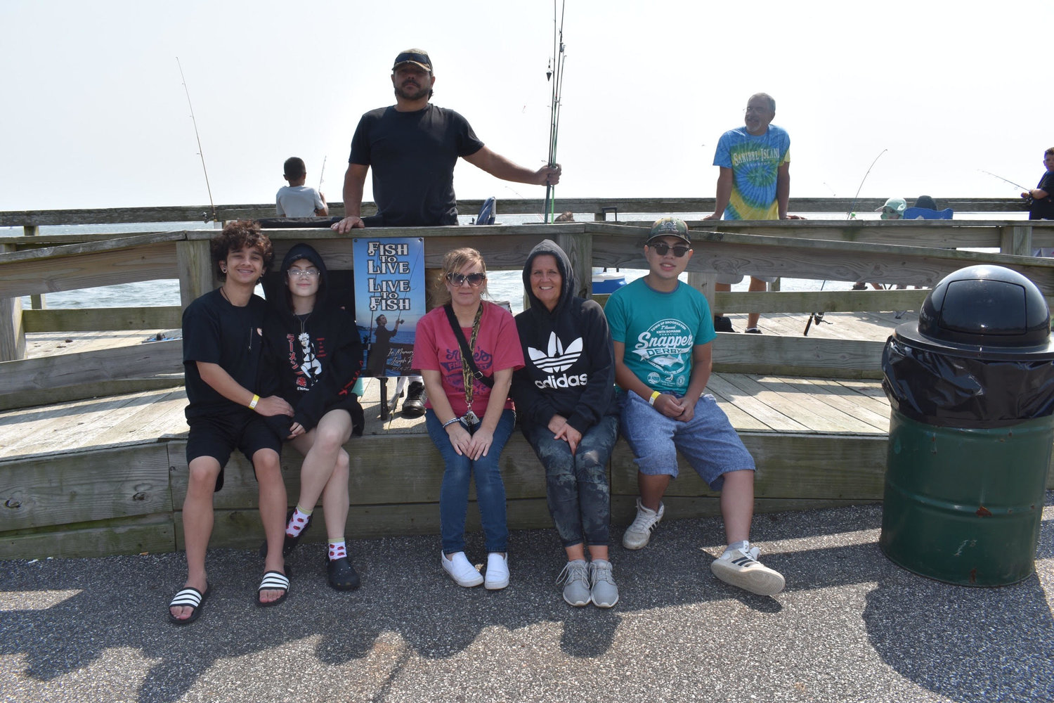 Joseph Rera’s family and friends gathered in front of his memorial plaque. His mother, Erin Rera, said Joseph was an avid fisherman who loved to spend his time with friends at the Union Avenue dock. Pictured is (in back) Derek Rera; (left to right) Frankie Villani; Alexa Rera; Erin Rera; Denise Trionfo; and Joseph Trionfo.